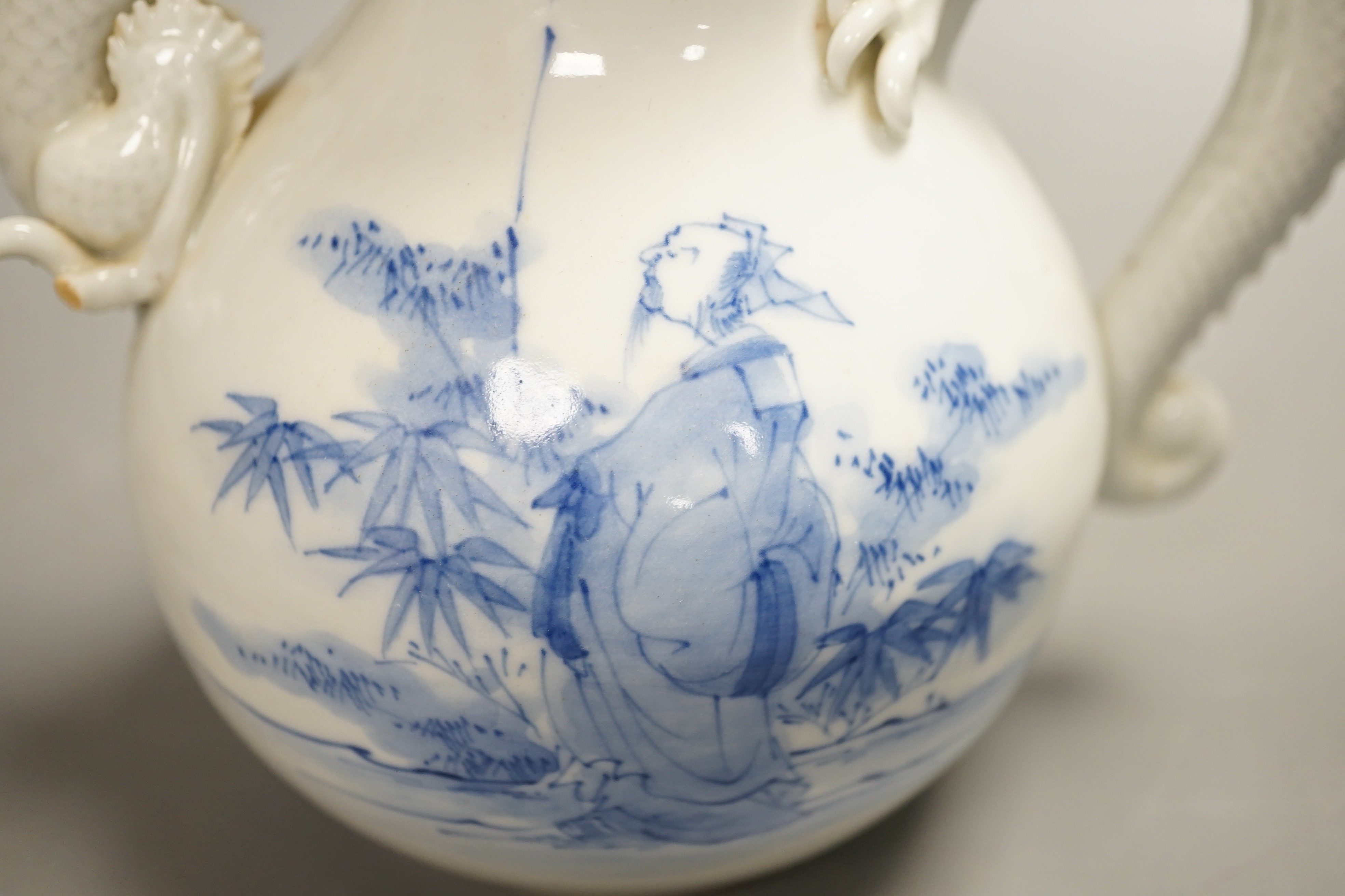 A Japanese Hirado blue and white 'dragon' wine pot, late 19th century, of double gourd shape, (losses) 19.5cm